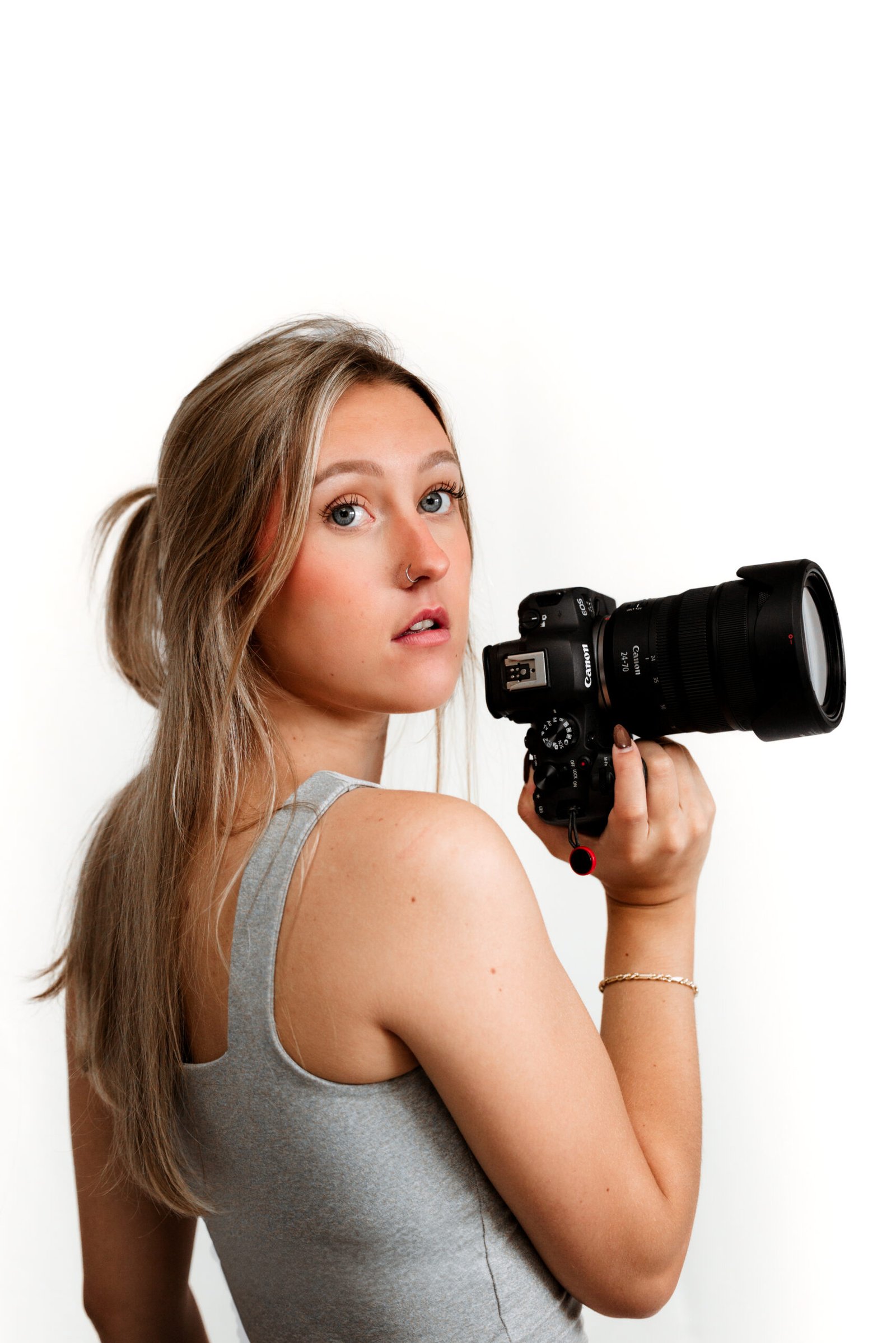 Photo of the owner, Chloe holding her camera in the studio.