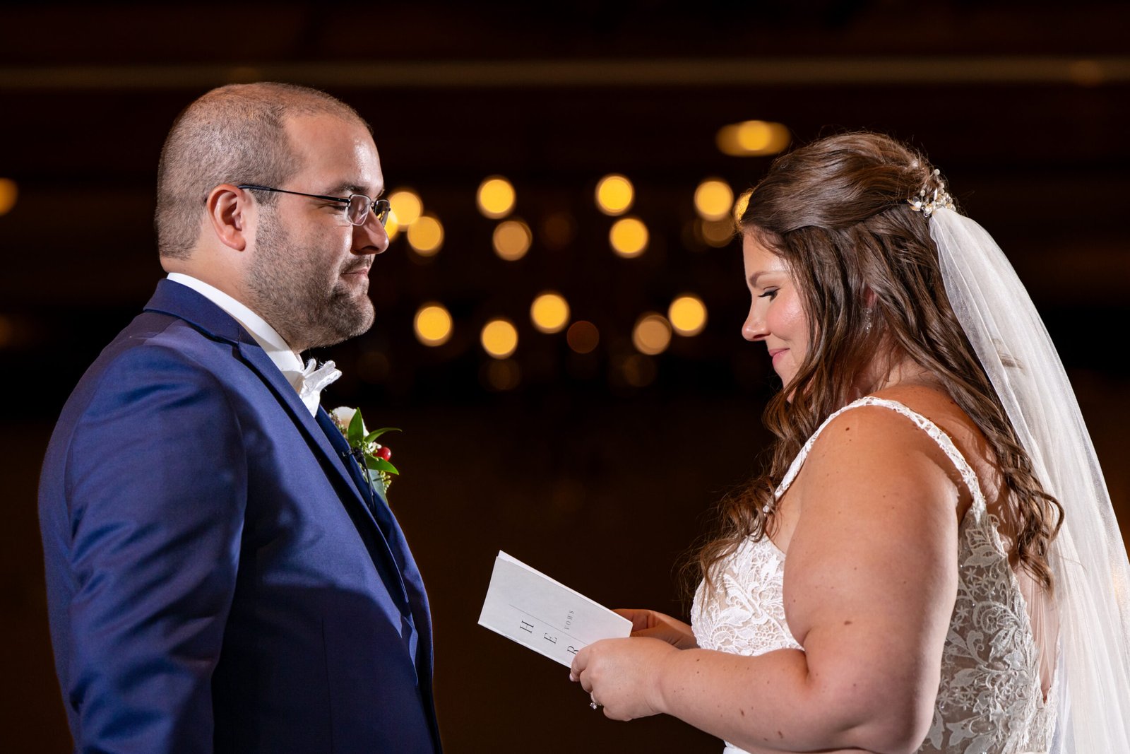 Bride and groom reading their private vows to one another.