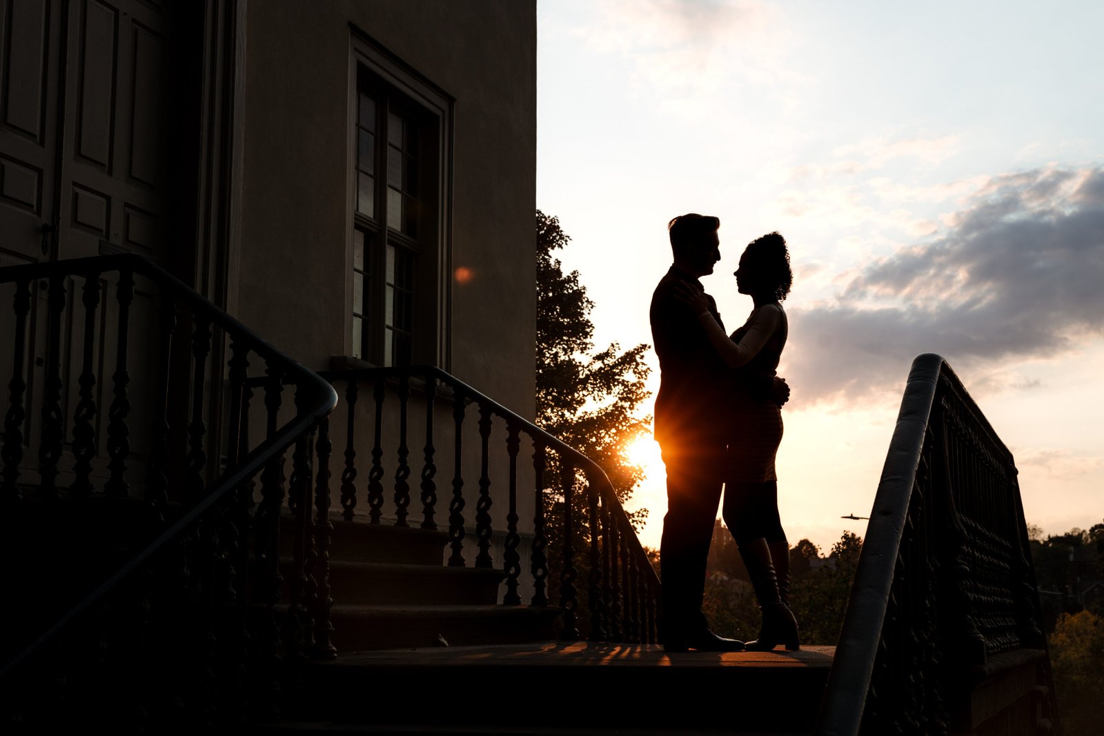 Couple sunset silhouette photo outside the church.